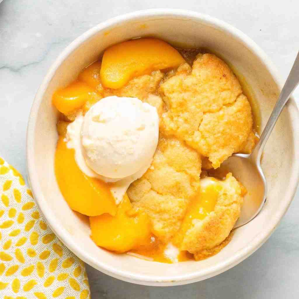 3-Ingredient Peach Cobbler - moist with a dollop of whipped topping