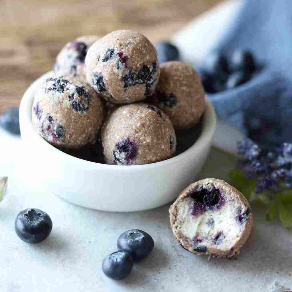 Blueberry Cheesecake Protein Bites - moist with a dollop of whipped topping