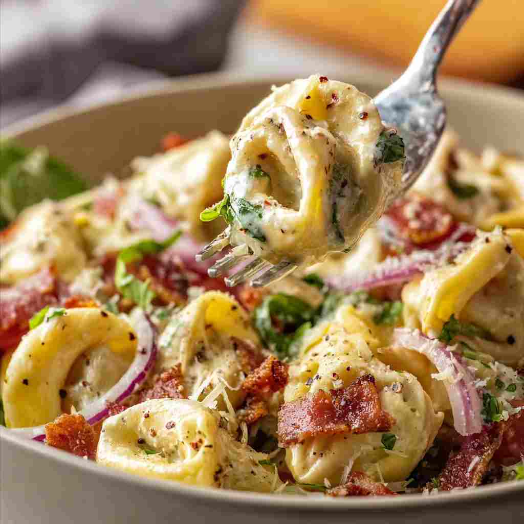Italian Grinder Tortellini Salad - delicate fresh leaves tossed with vibrant seasonal toppings with fresh cracked pepper and lemon wedges
